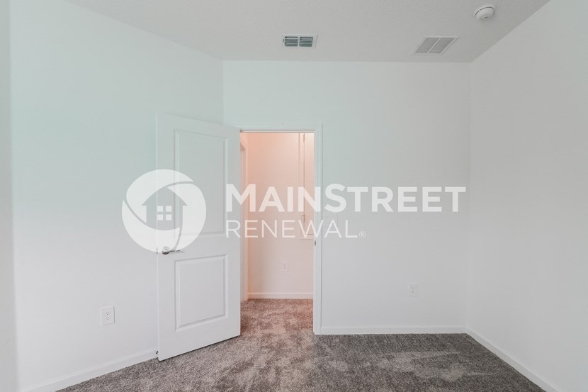 renovated living room with carpeted flooring and white walls