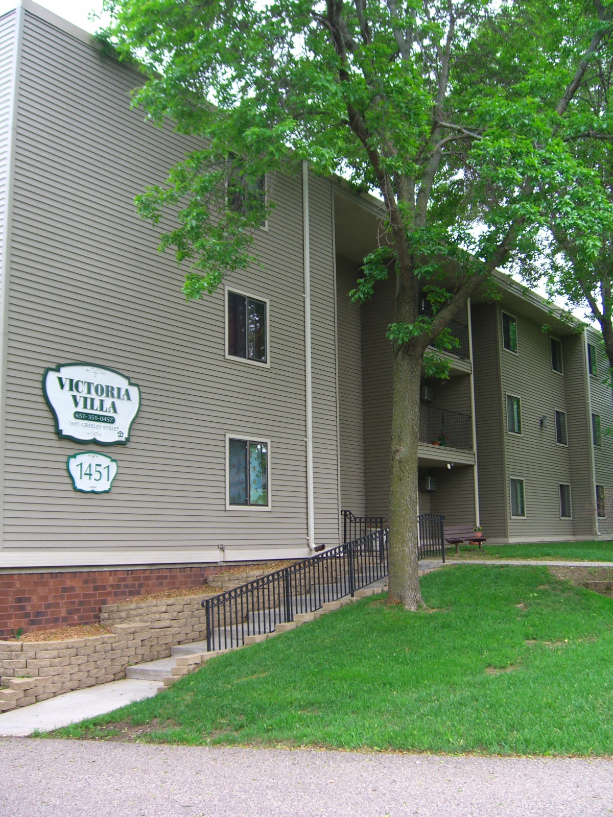 an apartment building with a sign on the side of it