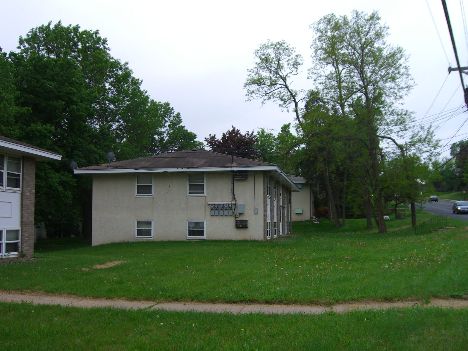a white house with a lawn and trees