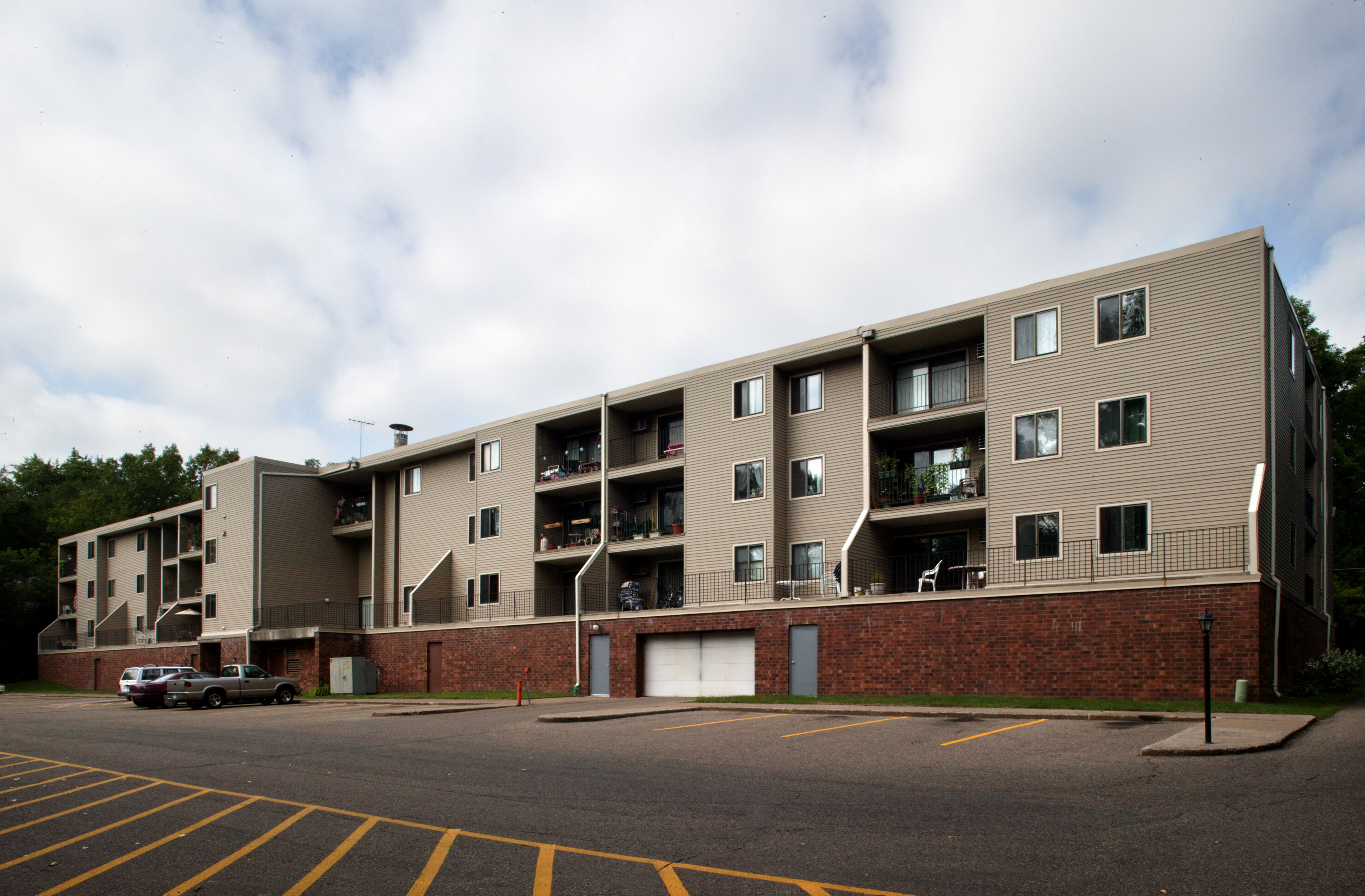 an apartment building with a car parked in front of it