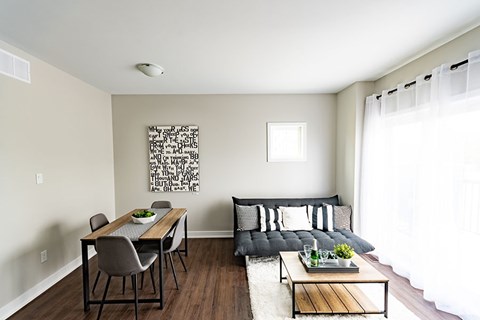A modern living room with a dining table and a couch.