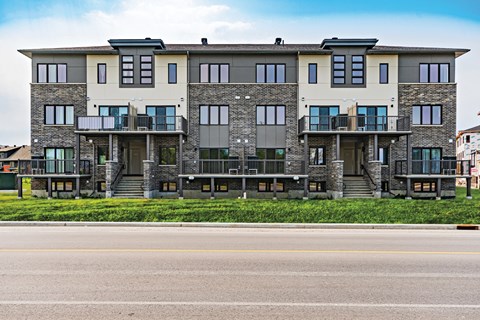 A large, modern building with a balcony on the second floor.
