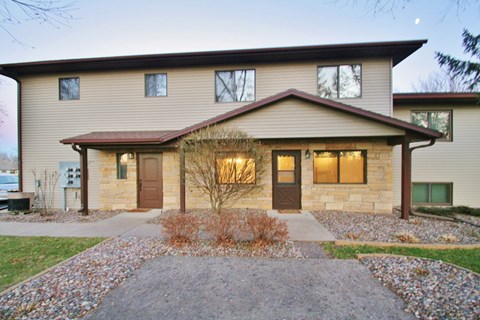 the front of a house with a walkway and a driveway