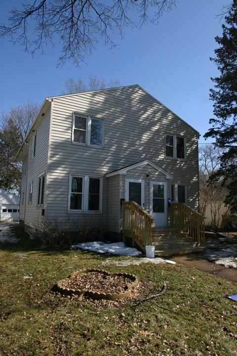 the back of a house with snow on the ground