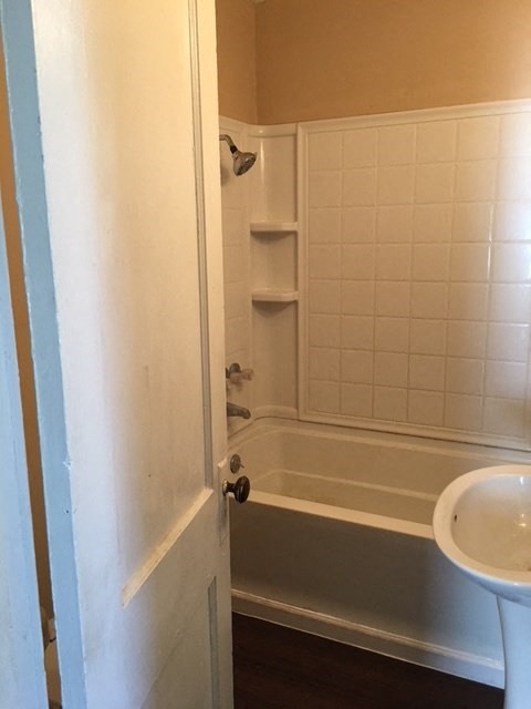 a bathroom with a bath tub and a sink