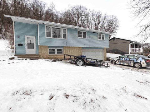 a house with a car parked in front of it in the snow