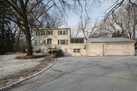 A large house with a driveway in front of it.
