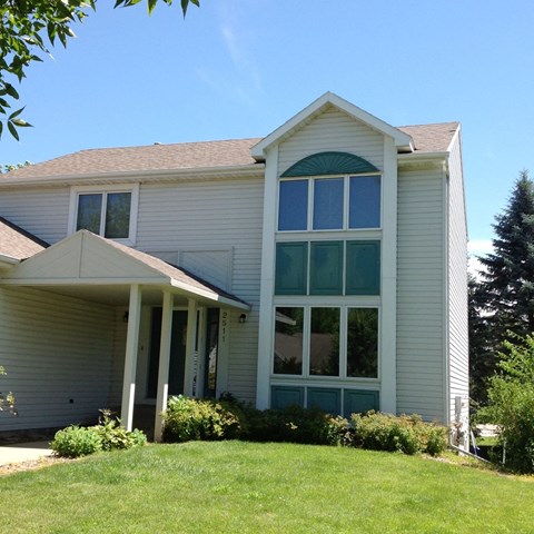 the front of a house with large windows