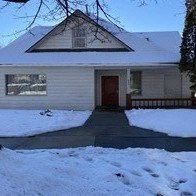 the front of a house covered in snow