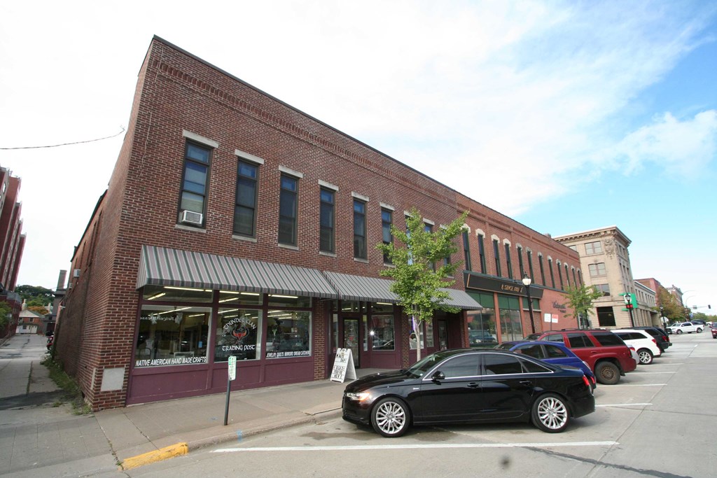 a small brick building with cars parked in front of it