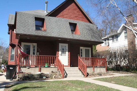 a house with a red porch and a gray roof