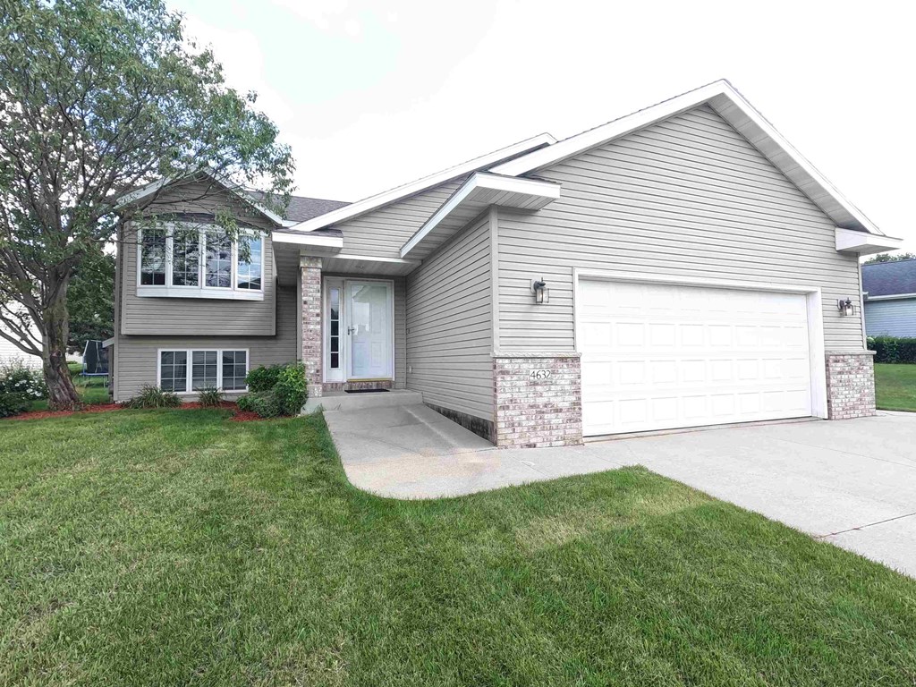 a home with a white garage door and a driveway