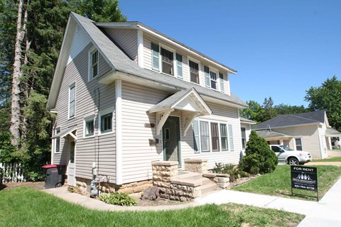 a white house with a sign in front of it