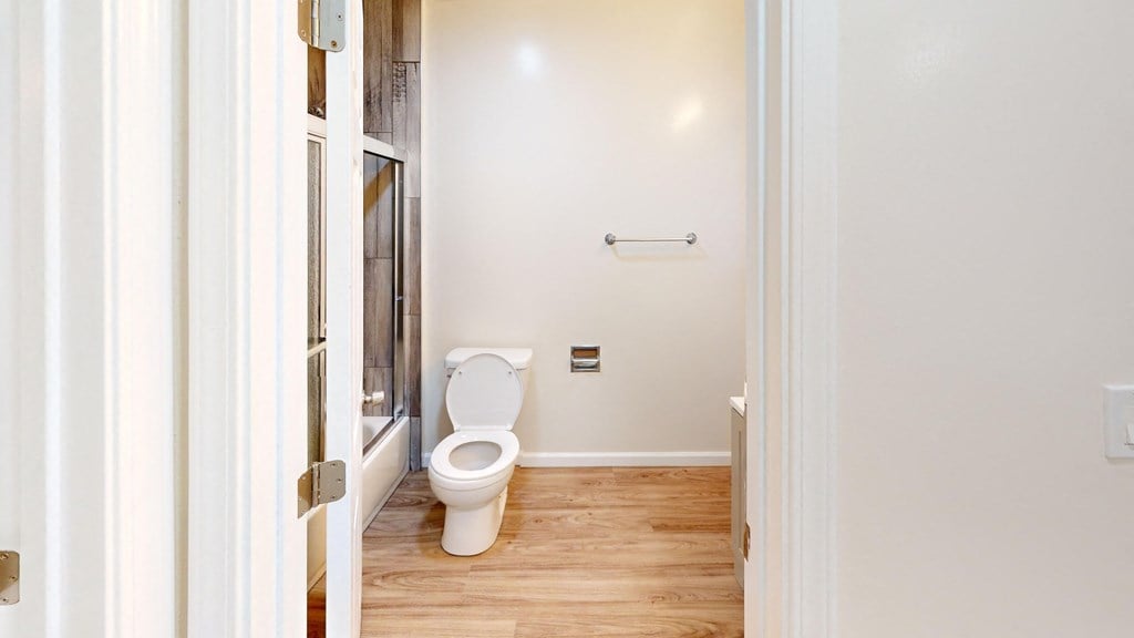 a bathroom with a toilet and a window