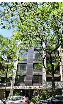 a tall building with trees in front of it