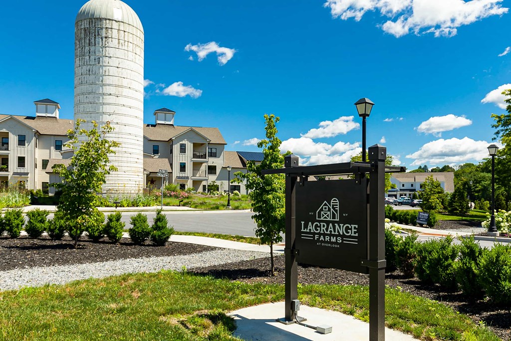 a sign in front of a building with a water tower