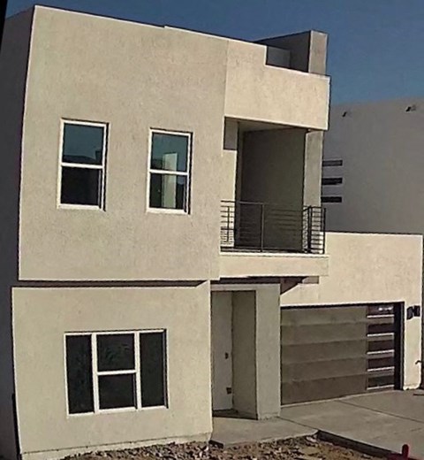 a white building with a balcony and a staircase