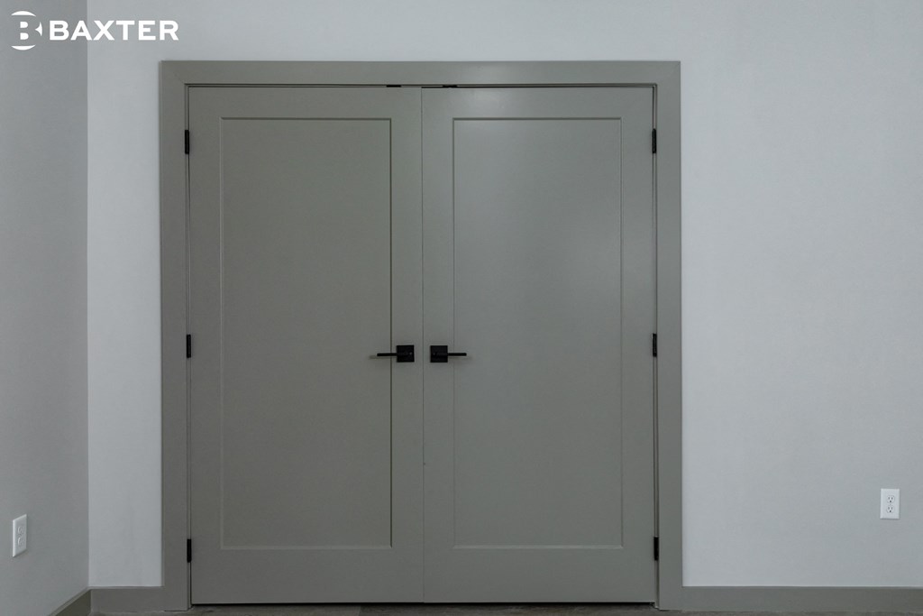 a pair of white doors in a white room