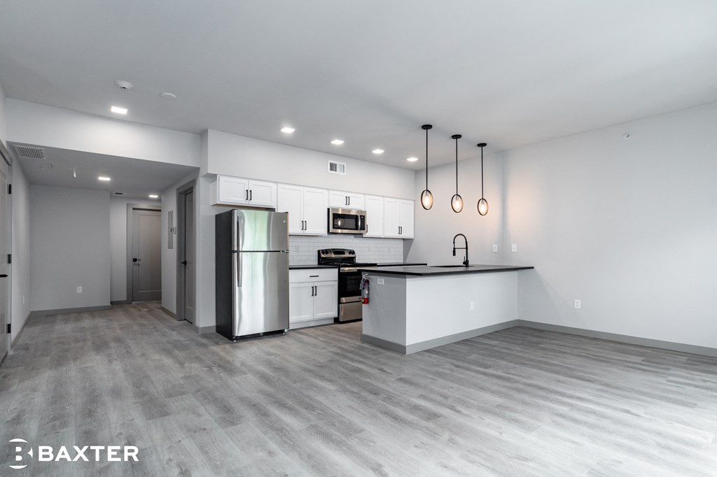 a renovated kitchen with white cabinets and stainless steel appliances