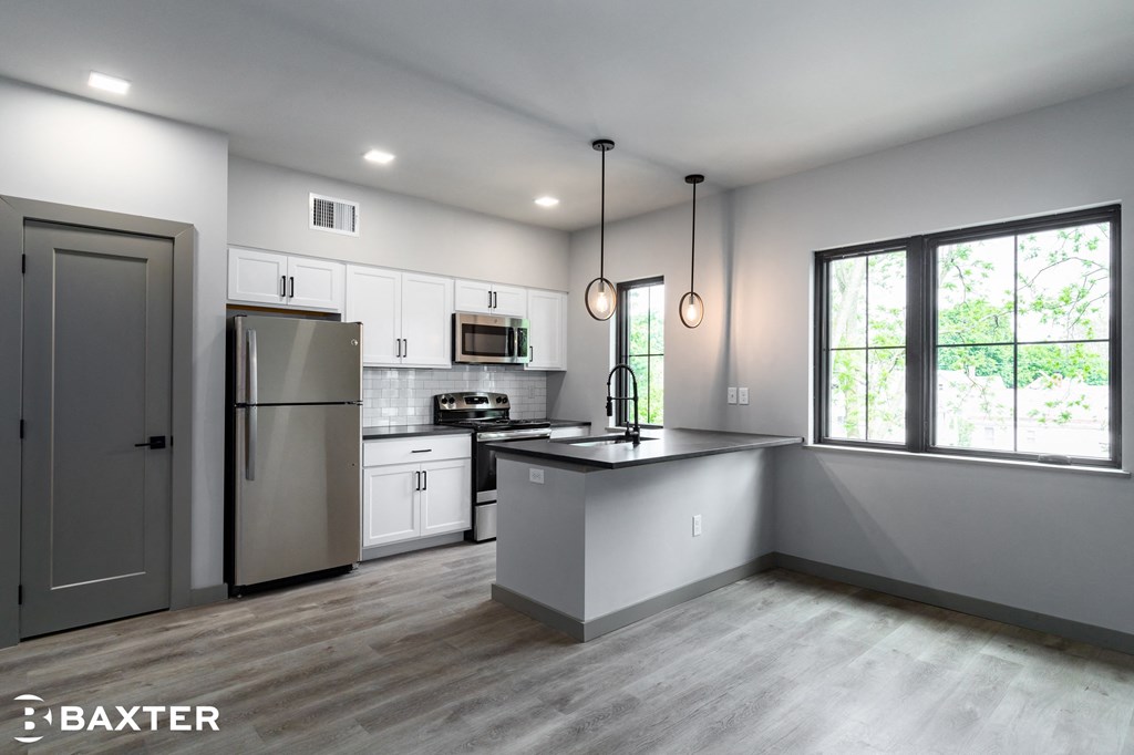 a kitchen with white cabinets and stainless steel appliances