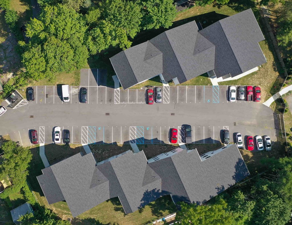 an aerial view of a parking lot with cars parked in it