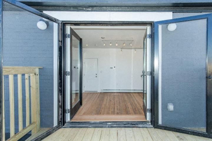 a large open door to a room with a wooden floor