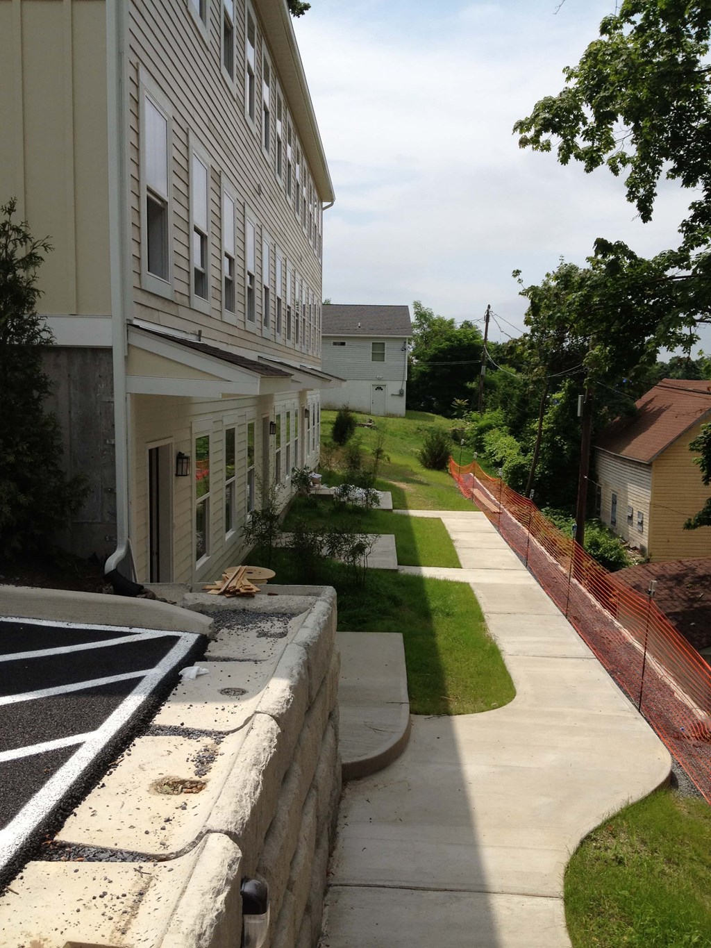 a view of the side of a building with a sidewalk