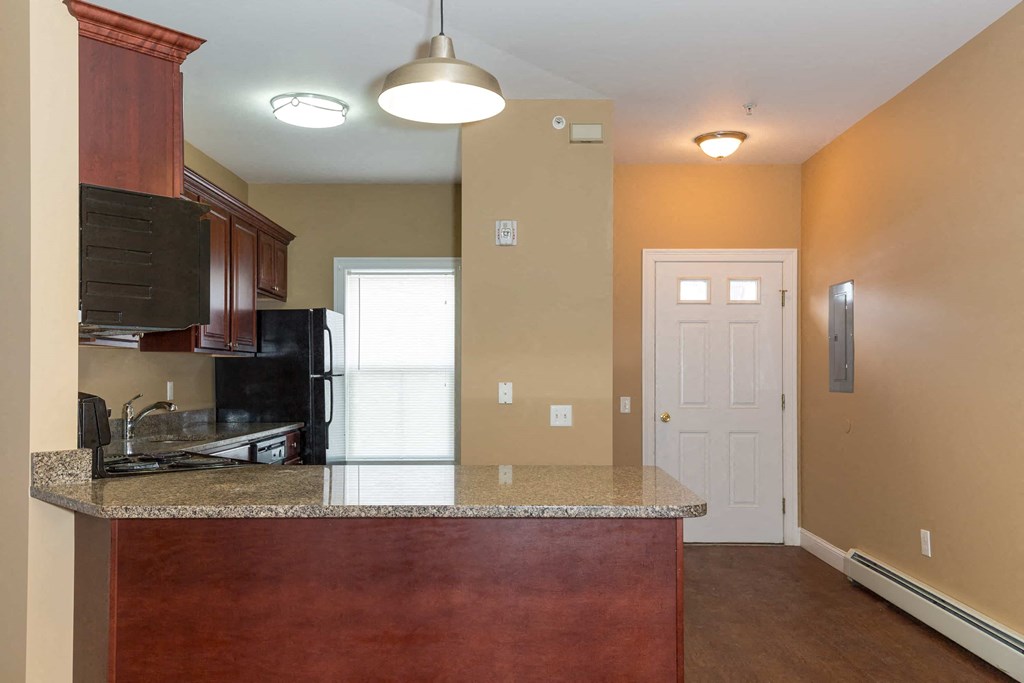 a kitchen with a counter and a door to a room