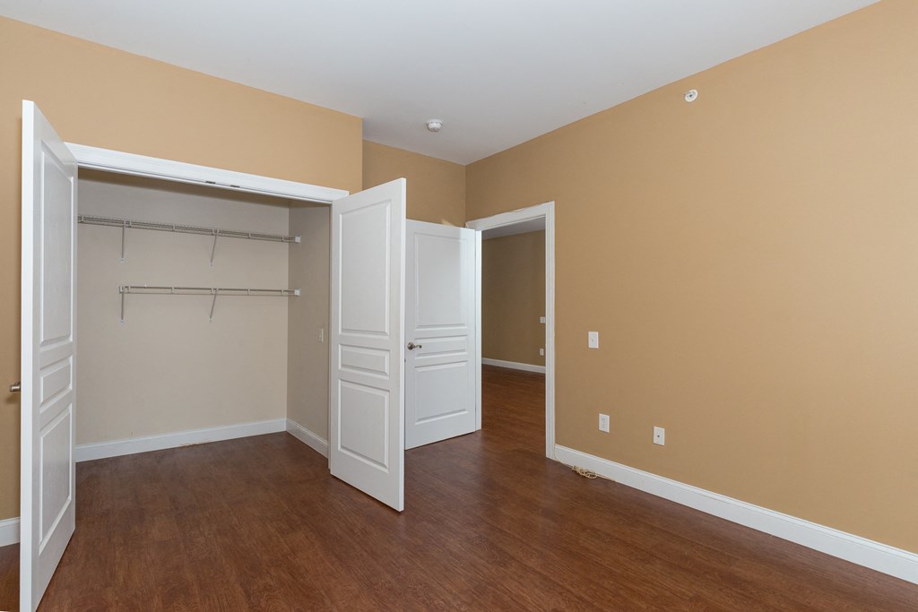 an empty room with a closet and an open door