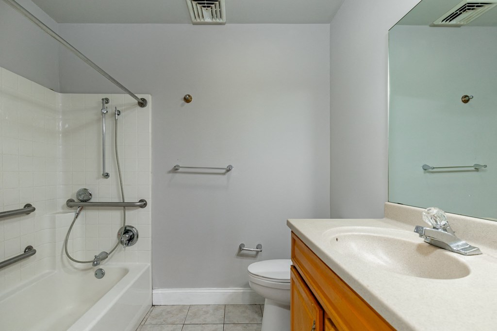 a bathroom with a shower toilet and sink and a mirror