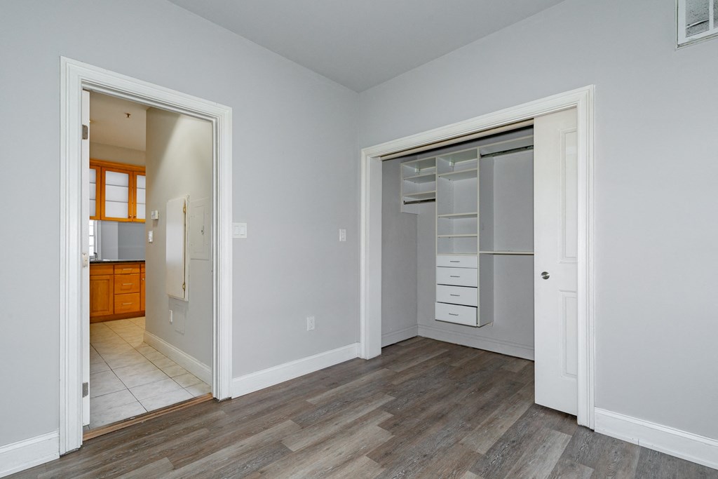 a bedroom with a closet and a door to a bathroom