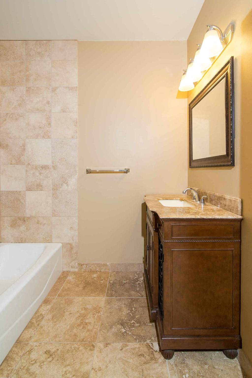 a bathroom with a sink and a tub and a mirror