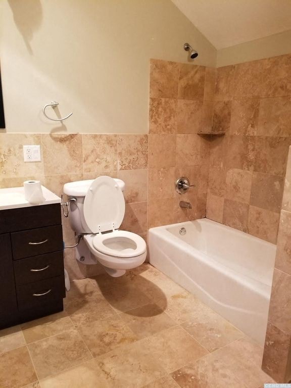 a bathroom with a toilet and a bath tub