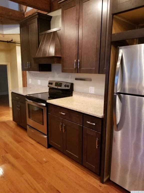 a kitchen with stainless steel appliances and wooden cabinets