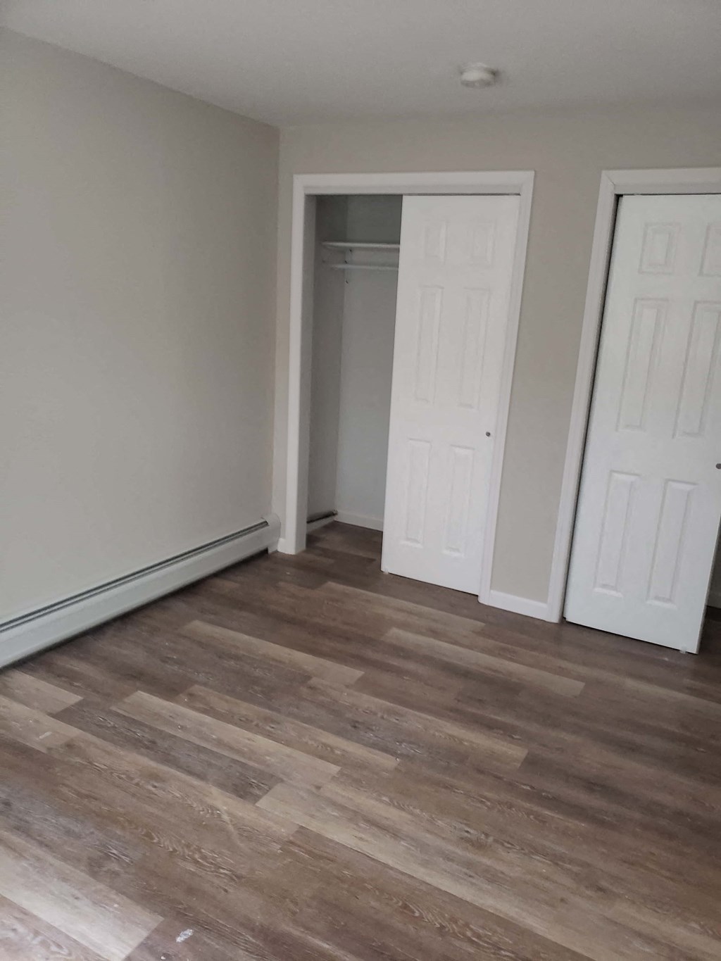 a living room with wood floors and a closet