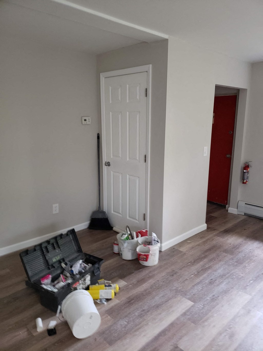 the living room is being remodeled and the door is open to the kitchen