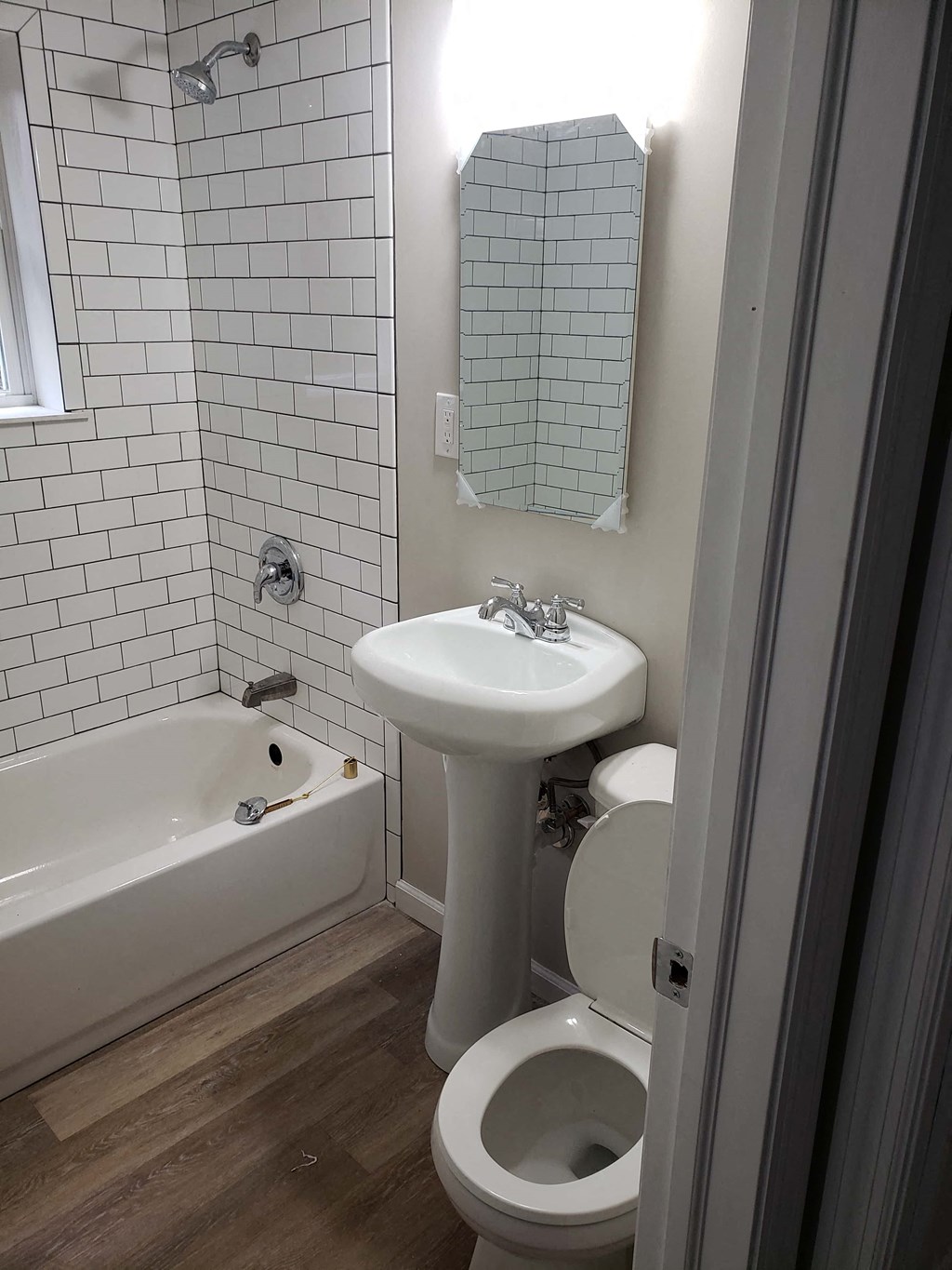 a small bathroom with a sink toilet and bath tub