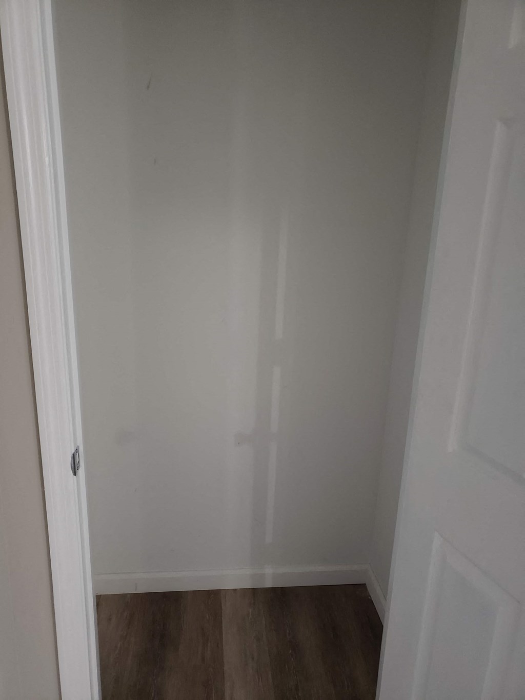 a room with white walls and a wooden floor