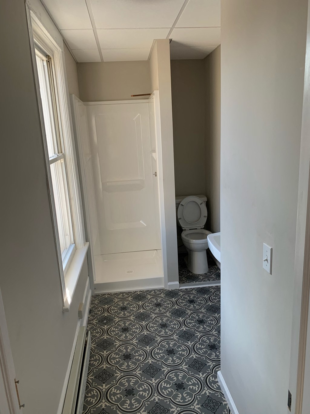 a small bathroom with a white toilet and a door