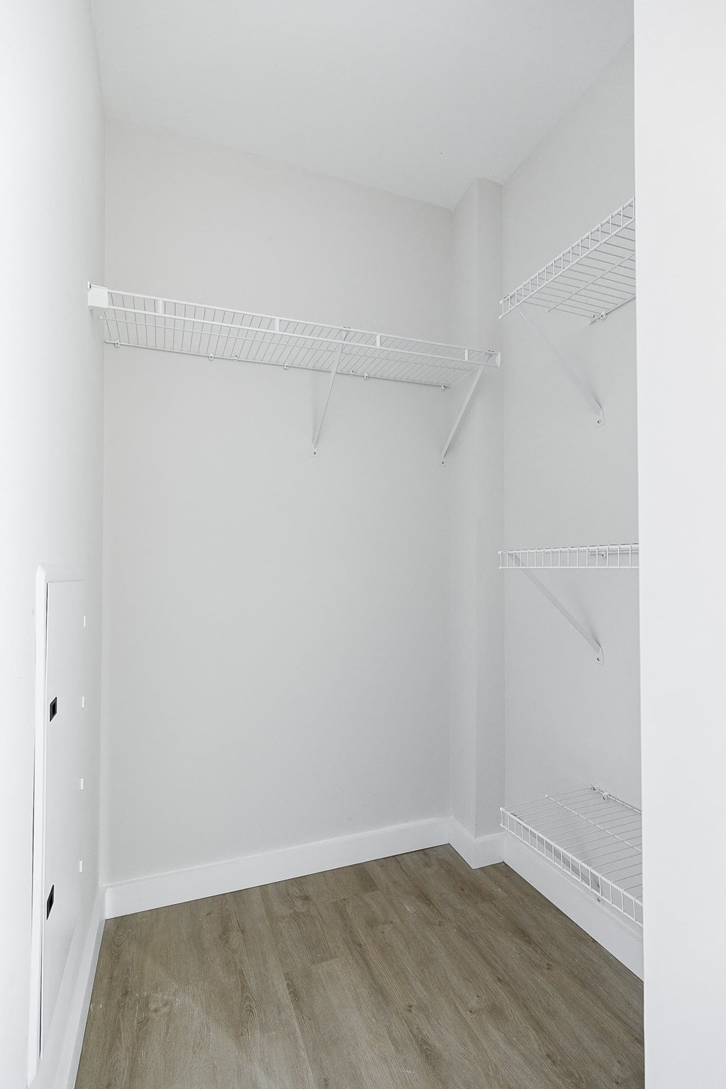 an empty room with white walls and a white closet