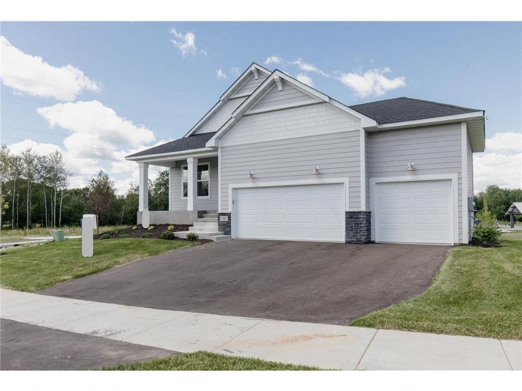 a white house with a garage and a driveway