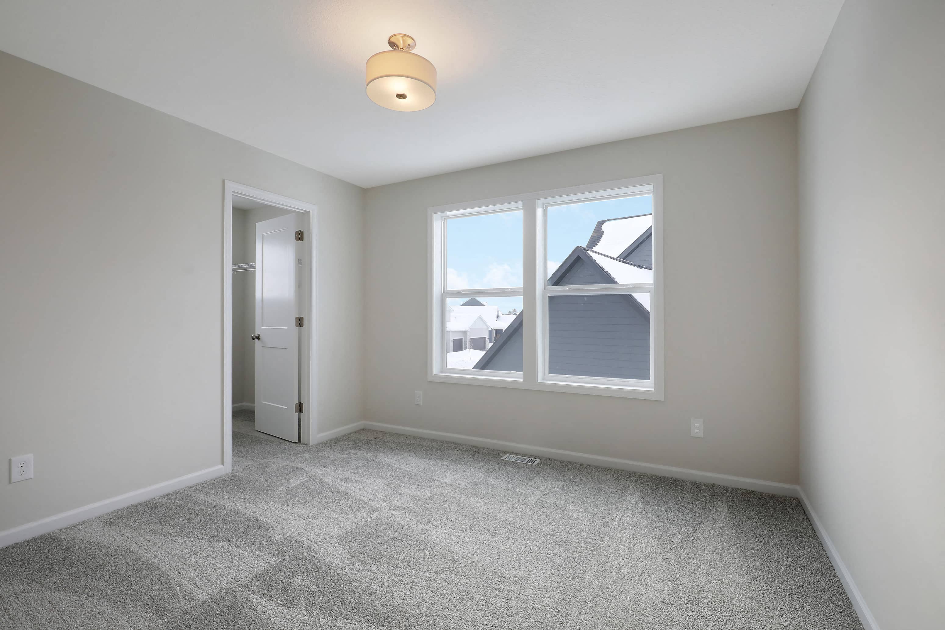 a living room with a large window and a door