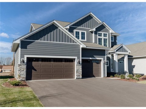 a house with a garage door in front of it