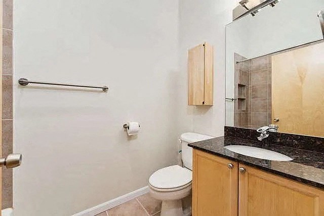 a bathroom with a toilet and a sink and a mirror