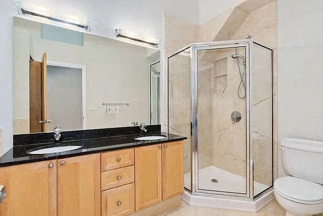 a bathroom with a sink toilet and shower