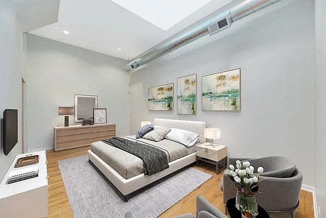 a bedroom with a bed and a couch and a chair