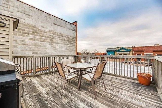 a deck with a table and chairs on it