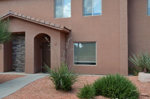 A house with a red brick exterior and a stone pillar in the front.