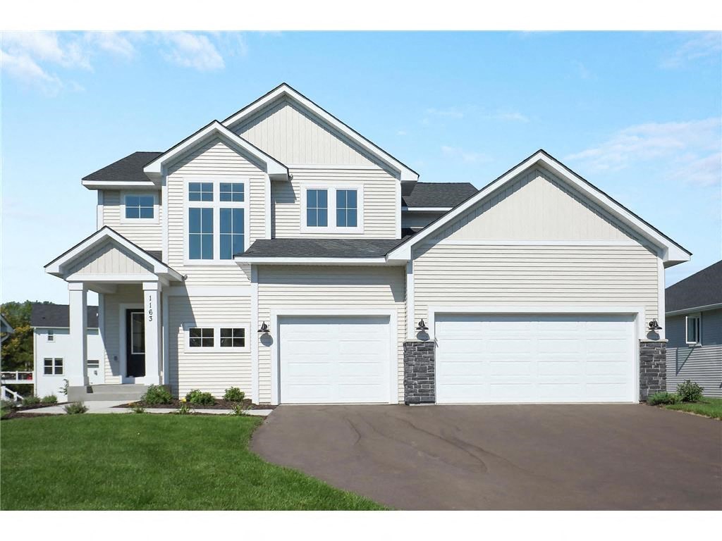 a white house with a garage and a driveway