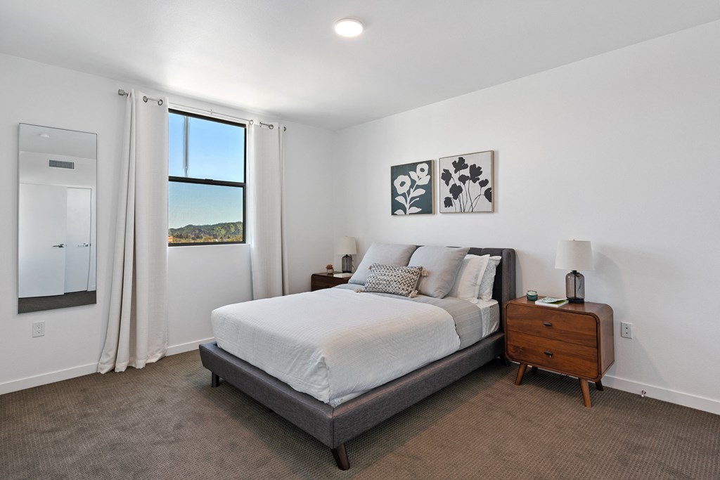 a bedroom with a bed and a window